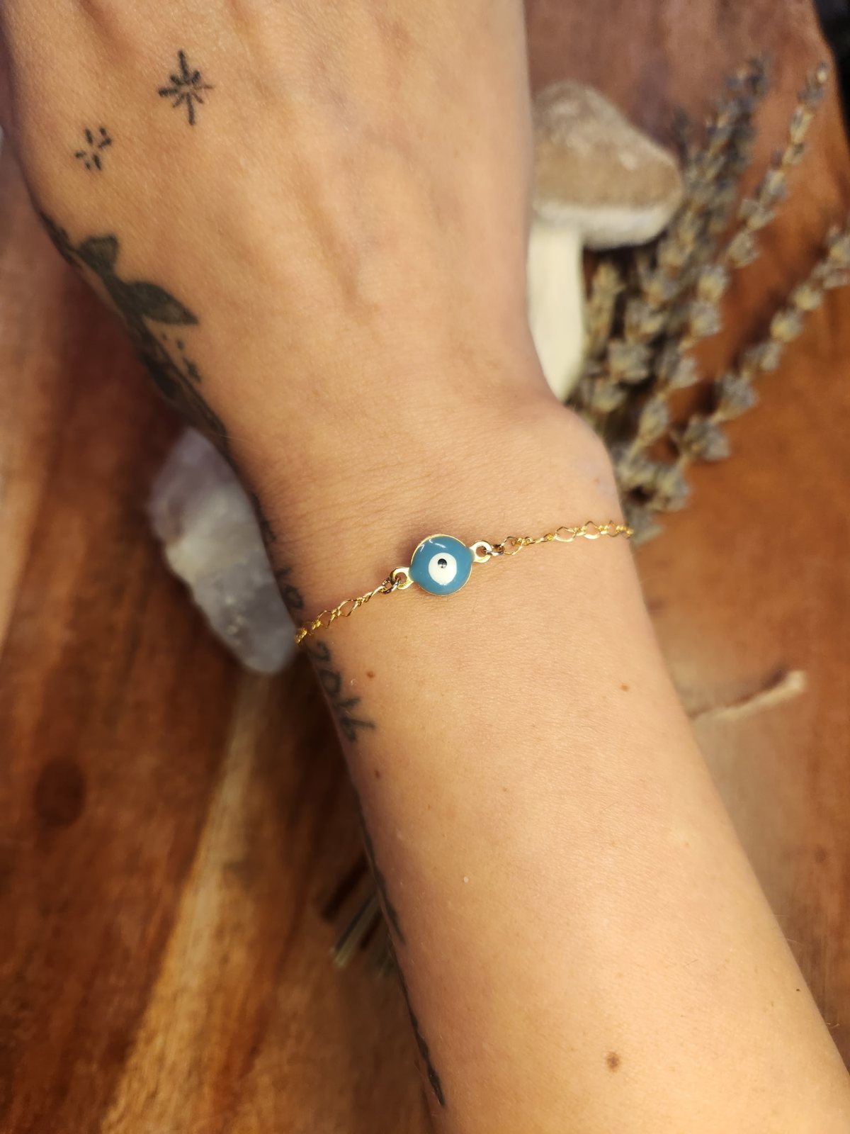 Gold permanent bracelet with blue evil eye charm
