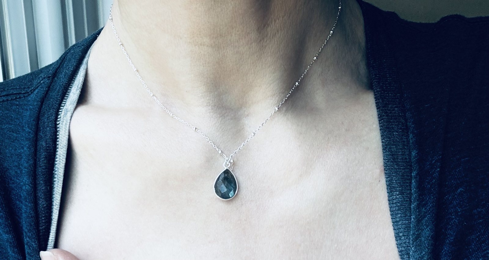 Silver necklace with dark gemstone pendant